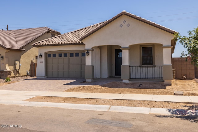 mediterranean / spanish-style house with a garage