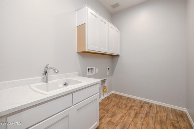 laundry room featuring hookup for an electric dryer, light hardwood / wood-style floors, sink, cabinets, and washer hookup