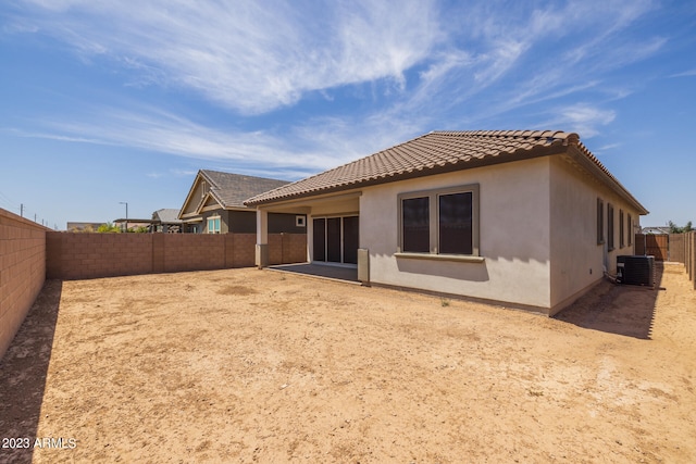 rear view of house featuring central AC