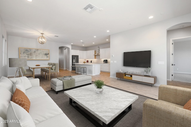 living room featuring a chandelier and carpet flooring