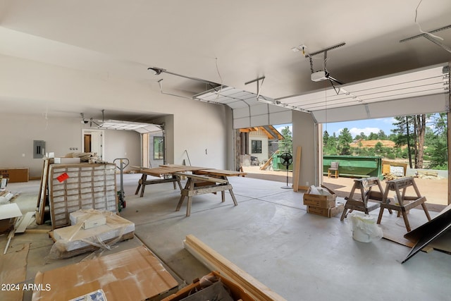 garage featuring electric panel and a garage door opener