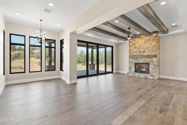 1804 E Senna Pt, Payson, AZ 85541 - unfurnished living room featuring a fireplace, a healthy amount of sunlight, beam ceiling, and visible vents