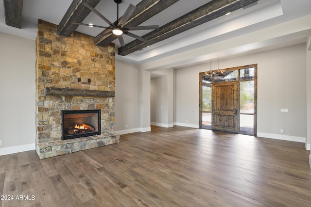 1804 E Senna Pt, Payson, AZ 85541 - unfurnished living room featuring wood finished floors, beam ceiling, baseboards, ceiling fan, and a stone fireplace