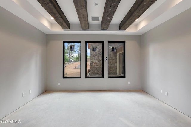 spare room with beamed ceiling