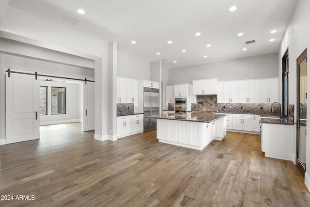 1804 E Senna Pt, Payson, AZ 85541 - kitchen with a sink, tasteful backsplash, a barn door, a center island, and stainless steel built in fridge