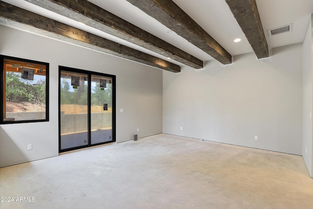 empty room featuring beam ceiling