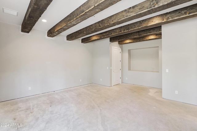 empty room featuring beam ceiling