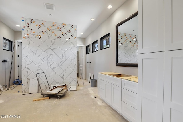 bathroom with vanity, concrete floors, and toilet