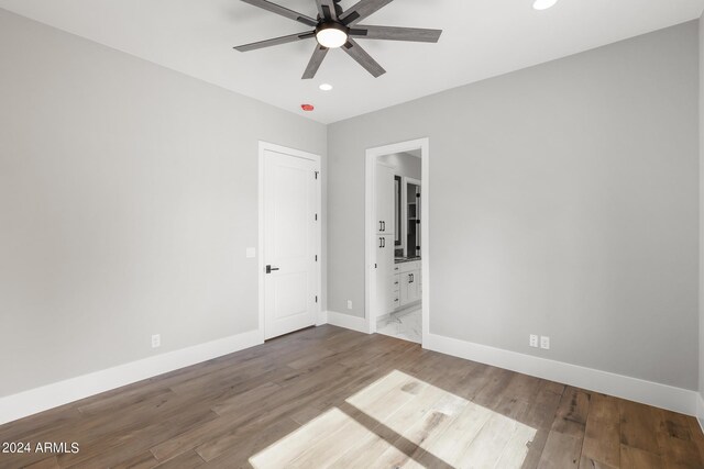 1804 E Senna Pt, Payson, AZ 85541 - unfurnished bedroom featuring baseboards, ensuite bathroom, recessed lighting, and wood finished floors