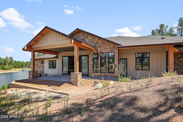 view of front of home featuring a water view and a patio