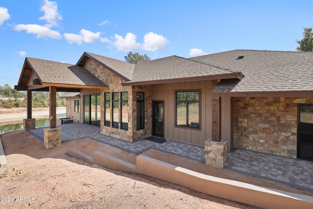 1804 E Senna Pt, Payson, AZ 85541 - exterior space with stone siding, a patio, roof with shingles, and board and batten siding
