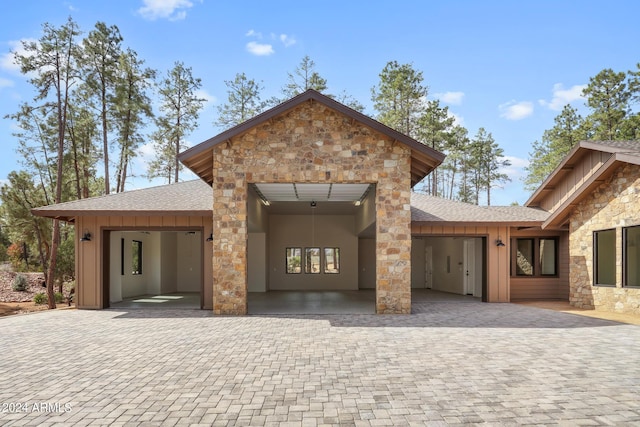 1804 E Senna Pt, Payson, AZ 85541 - view of front of house featuring stone siding, an attached garage, decorative driveway, and board and batten siding