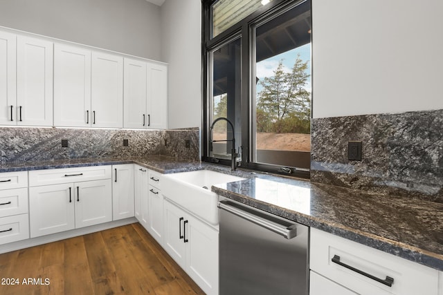 kitchen with stainless steel dishwasher, dark wood-type flooring, and white cabinets