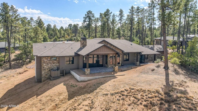 1804 E Senna Pt, Payson, AZ 85541 - rear view of property featuring a patio area, a shingled roof, a chimney, and stone siding