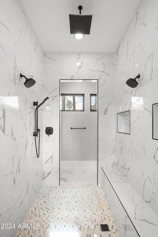 bathroom with a tile shower