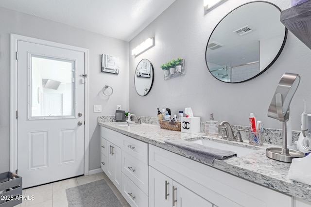 bathroom featuring tile patterned floors, visible vents, and a sink