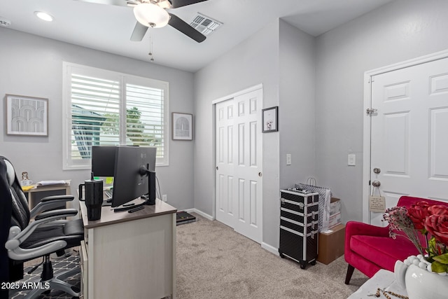 carpeted office space with visible vents, baseboards, and ceiling fan