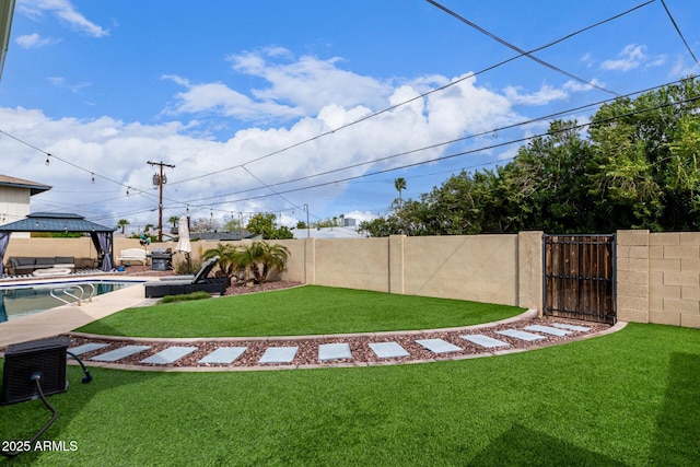 view of yard with a gazebo, a gate, a fenced backyard, and a fenced in pool