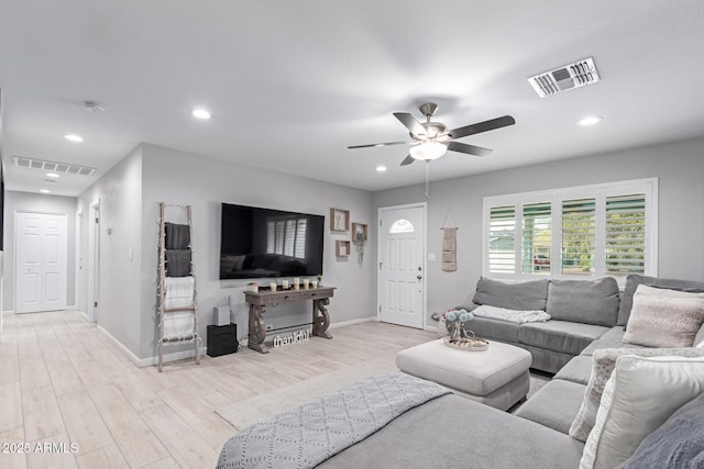 living area with visible vents, recessed lighting, ceiling fan, and wood finished floors