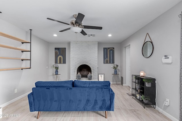 living room with baseboards, light wood finished floors, and ceiling fan