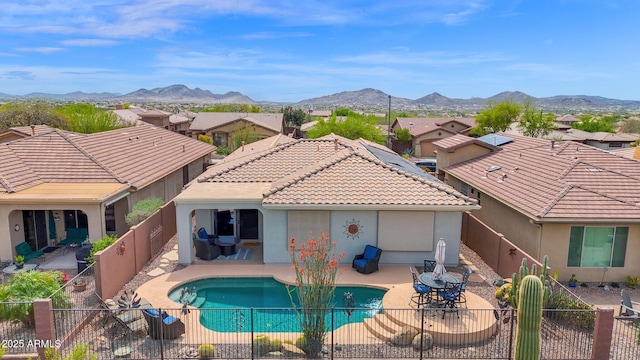 2452 W Muirfield Dr, Anthem, AZ 85086 - back of property with a tiled roof, a fenced backyard, stucco siding, a mountain view, and a patio area