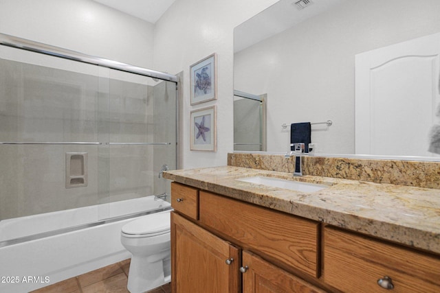 2452 W Muirfield Dr, Anthem, AZ 85086 - bathroom with tile patterned floors, toilet, vanity, bath / shower combo with glass door, and visible vents