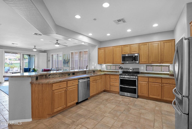 2452 W Muirfield Dr, Anthem, AZ 85086 - kitchen with recessed lighting, a sink, visible vents, a peninsula, and appliances with stainless steel finishes