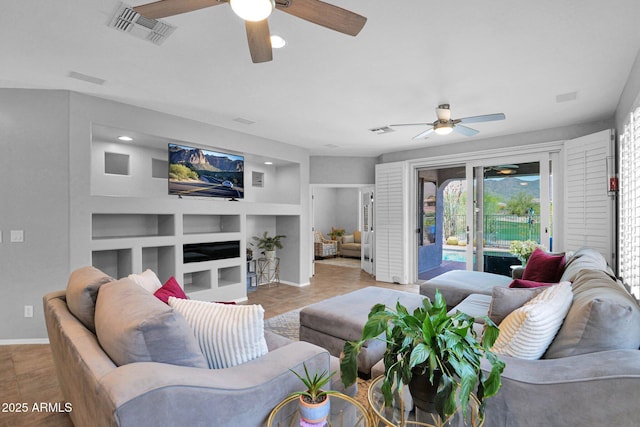 2452 W Muirfield Dr, Anthem, AZ 85086 - living area with baseboards, ceiling fan, visible vents, and built in shelves