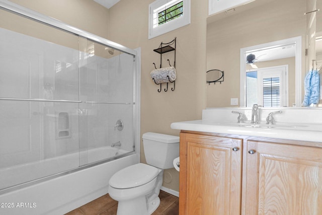 2452 W Muirfield Dr, Anthem, AZ 85086 - bathroom with tile patterned floors, toilet, vanity, enclosed tub / shower combo, and ceiling fan