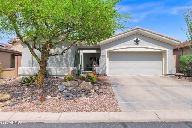 2452 W Muirfield Dr, Anthem, AZ 85086 - view of front of house with a tiled roof, driveway, stucco siding, and an attached garage