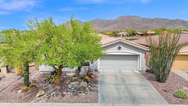 2452 W Muirfield Dr, Anthem, AZ 85086 - view of front of home with fence, an attached garage, a tile roof, driveway, and a mountain view