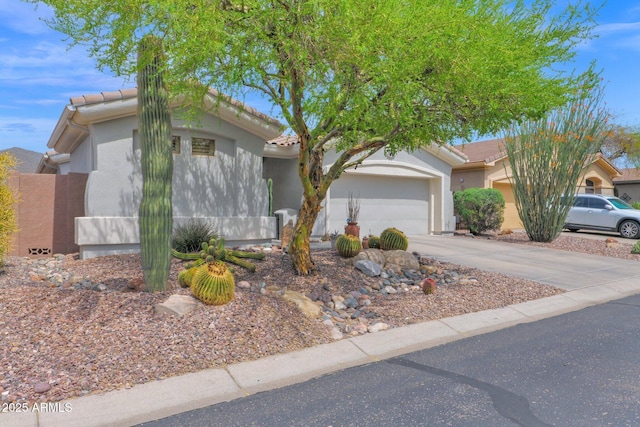2452 W Muirfield Dr, Anthem, AZ 85086 - view of front of property featuring a tiled roof, a garage, concrete driveway, and stucco siding