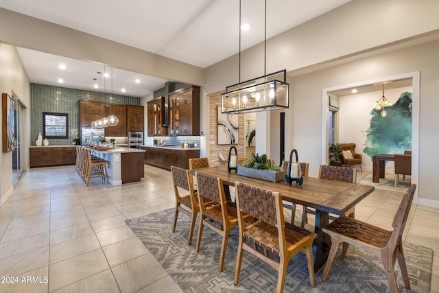 dining area featuring recessed lighting, a notable chandelier, baseboards, and light tile patterned floors