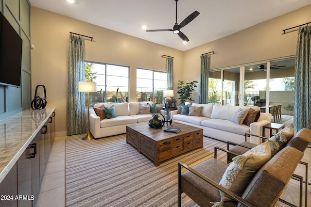 living area featuring a ceiling fan and light tile patterned flooring