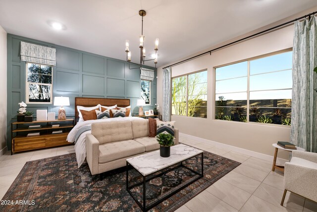 bedroom featuring baseboards, a decorative wall, light tile patterned flooring, and a notable chandelier