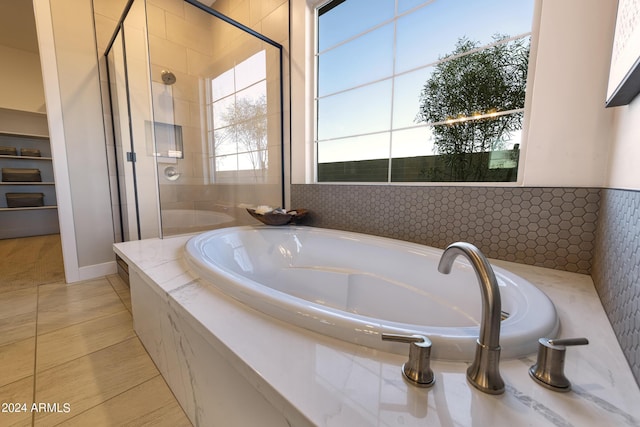 bathroom with a garden tub and a shower stall