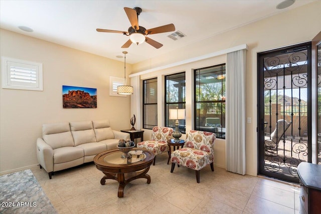 living room with light tile patterned floors and ceiling fan