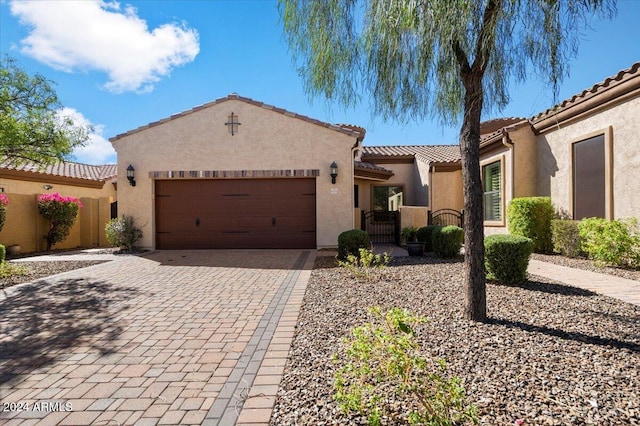 mediterranean / spanish-style home with a garage