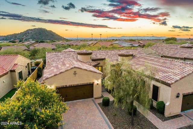 aerial view at dusk featuring a mountain view