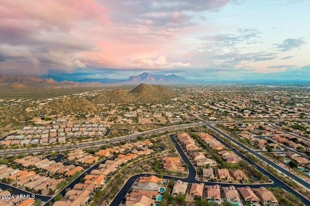 aerial view at dusk featuring a mountain view