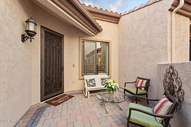 property entrance featuring a patio area