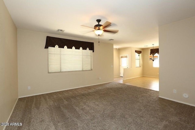 unfurnished room featuring ceiling fan and carpet floors