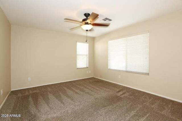 empty room with ceiling fan and carpet floors