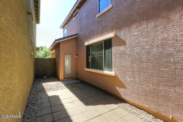 view of side of property featuring a patio area