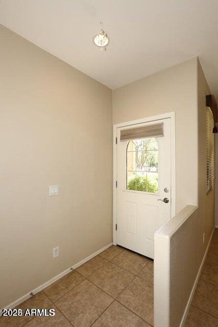 doorway to outside with tile patterned flooring