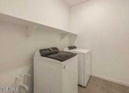 laundry area with tile patterned floors and washer and clothes dryer