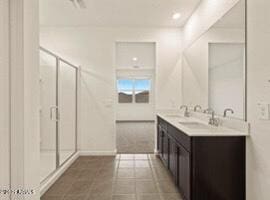 bathroom with vanity, tile patterned flooring, and a shower with door