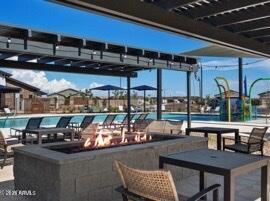 view of pool featuring an outdoor fire pit