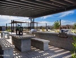 view of patio with a pergola and exterior kitchen