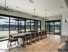 dining room featuring plenty of natural light, a chandelier, and hardwood / wood-style floors